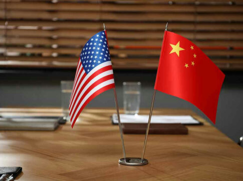 American and Chinese flags on a table.