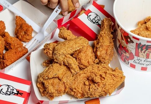 A variety of fried chicken pieces served in takeout containers